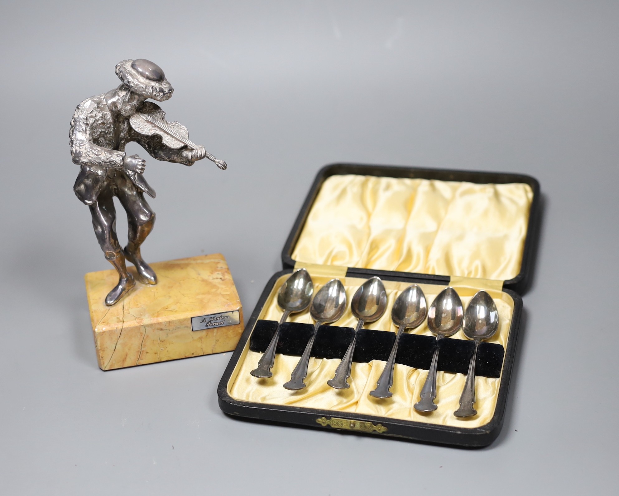 A 925 standard model of a violinist by A. Kedem of Israel, on marble plinth, 18cm, and a cased set of six silver coffee spoons